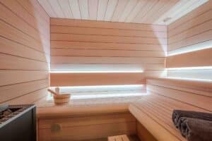 Zweireihige Holzsauna mit indirekter Beleuchtung von ERLER Haus.