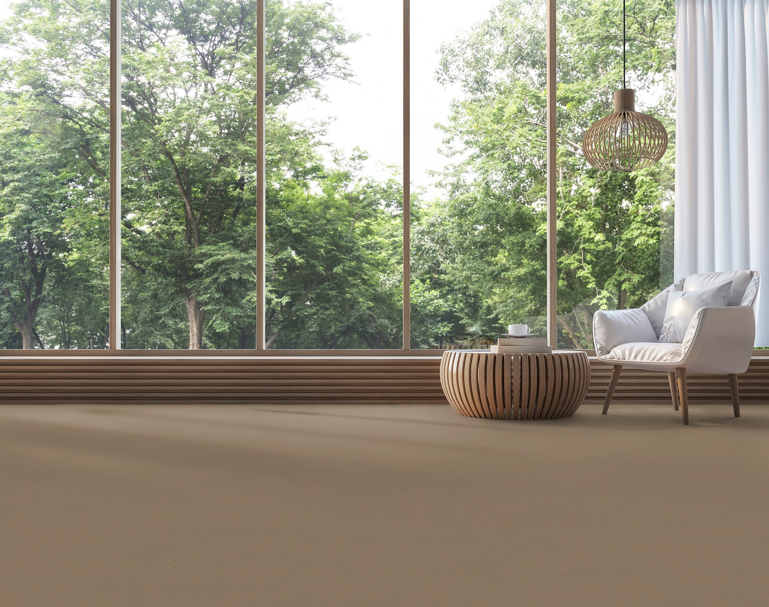 Gerflor präsentiert einen großen hellen Raum mit Sitzgelegenheit, großen Fensterflächen und einem mit Lino beschichteten Boden in einem Braunton.