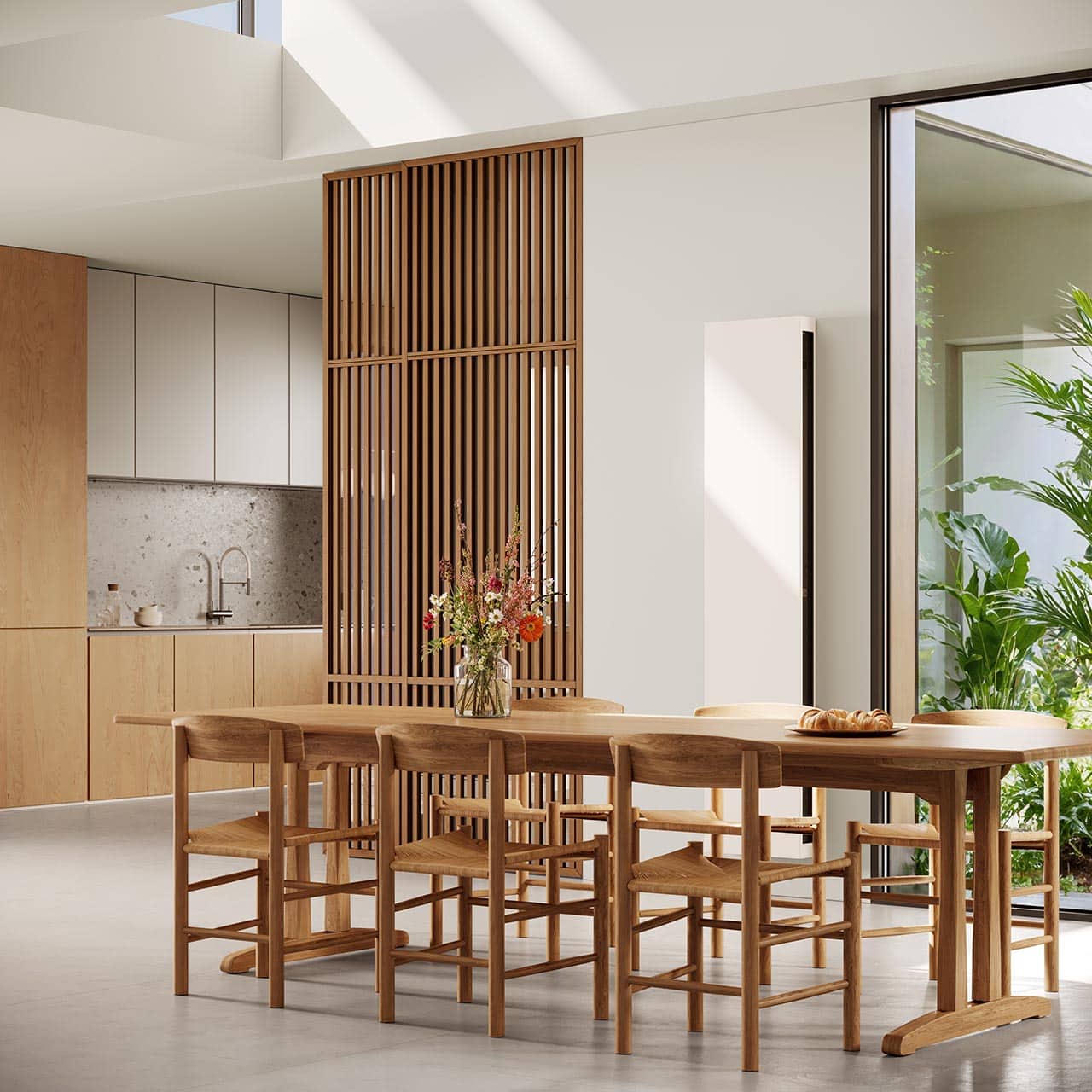 Offene Essküche mit weißem VertiLina Net Zero Wärmepumpen-Heizkörper von Jaga.